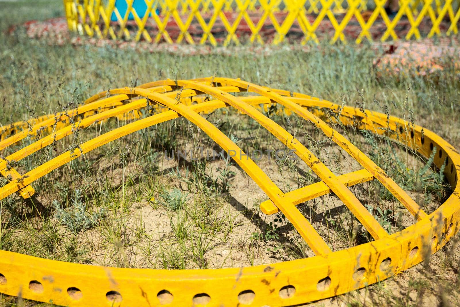 Shanyrak or shangyrak, wooden details of the Asian turkic yurt lie on the ground. Assembling the yurt in Kazakhstan steppe.