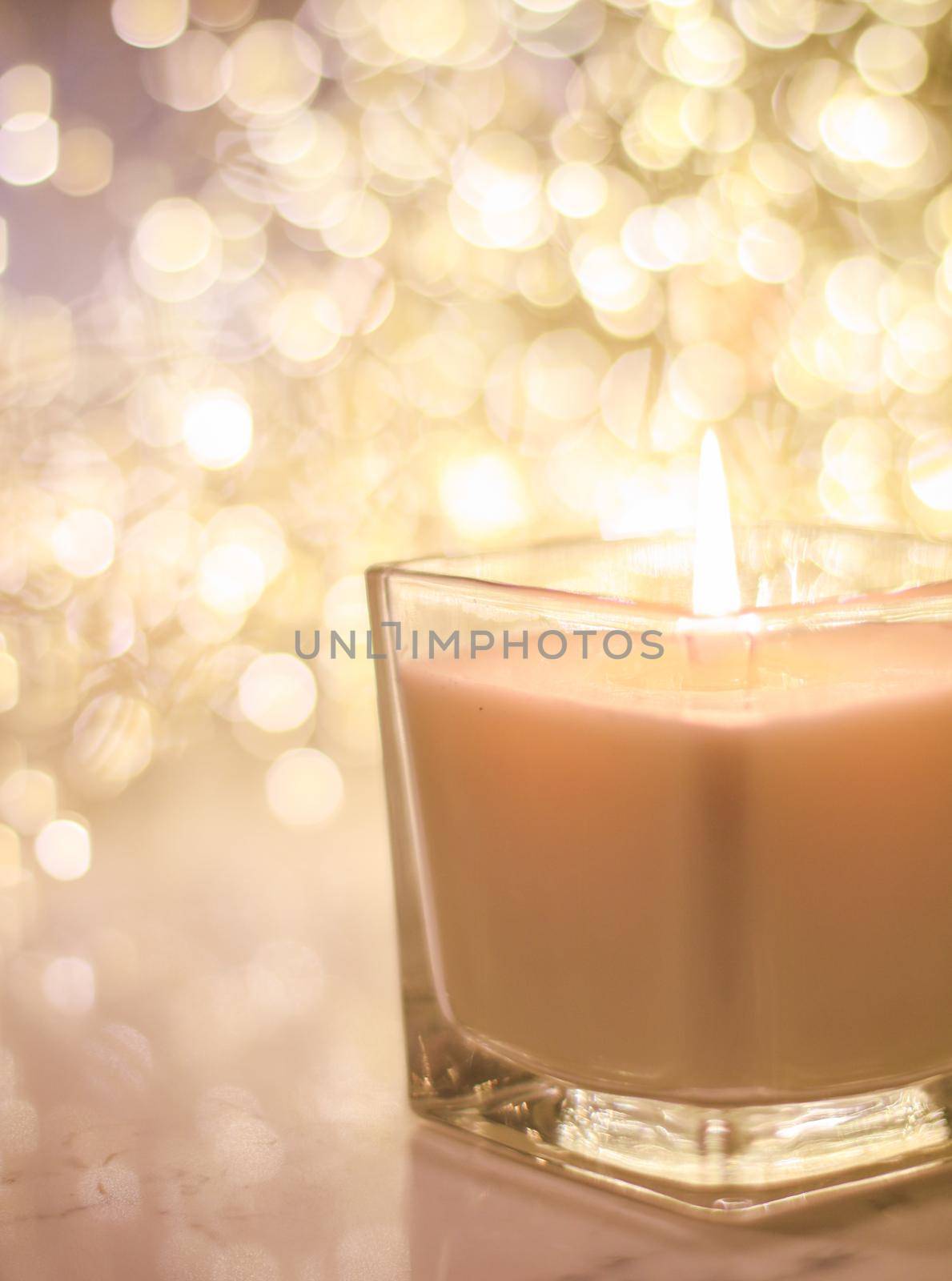 Festive decoration, branding and aromatherapy spa concept - Aromatic candle on golden Christmas and New Years glitter background, Valentines Day luxury home decor and holiday season brand design