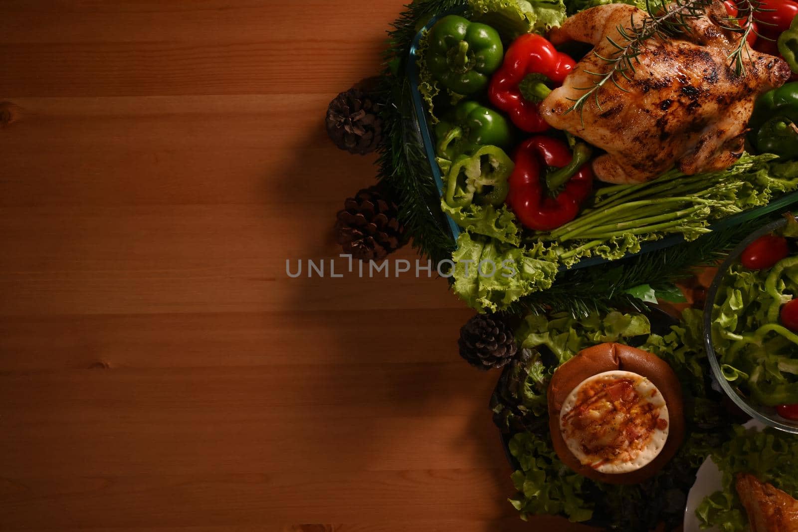 Traditional thanksgiving dinner with delicious roasted turkey and all sides dishes on wooden background. Copy space for your text by prathanchorruangsak