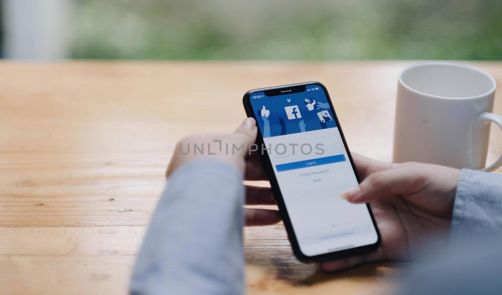 Chiang Mai Thailand. Mar 08, 2022. Woman holds smart phone with facebook application on the screen. facebook is a photo-sharing app for smartphones by wichayada