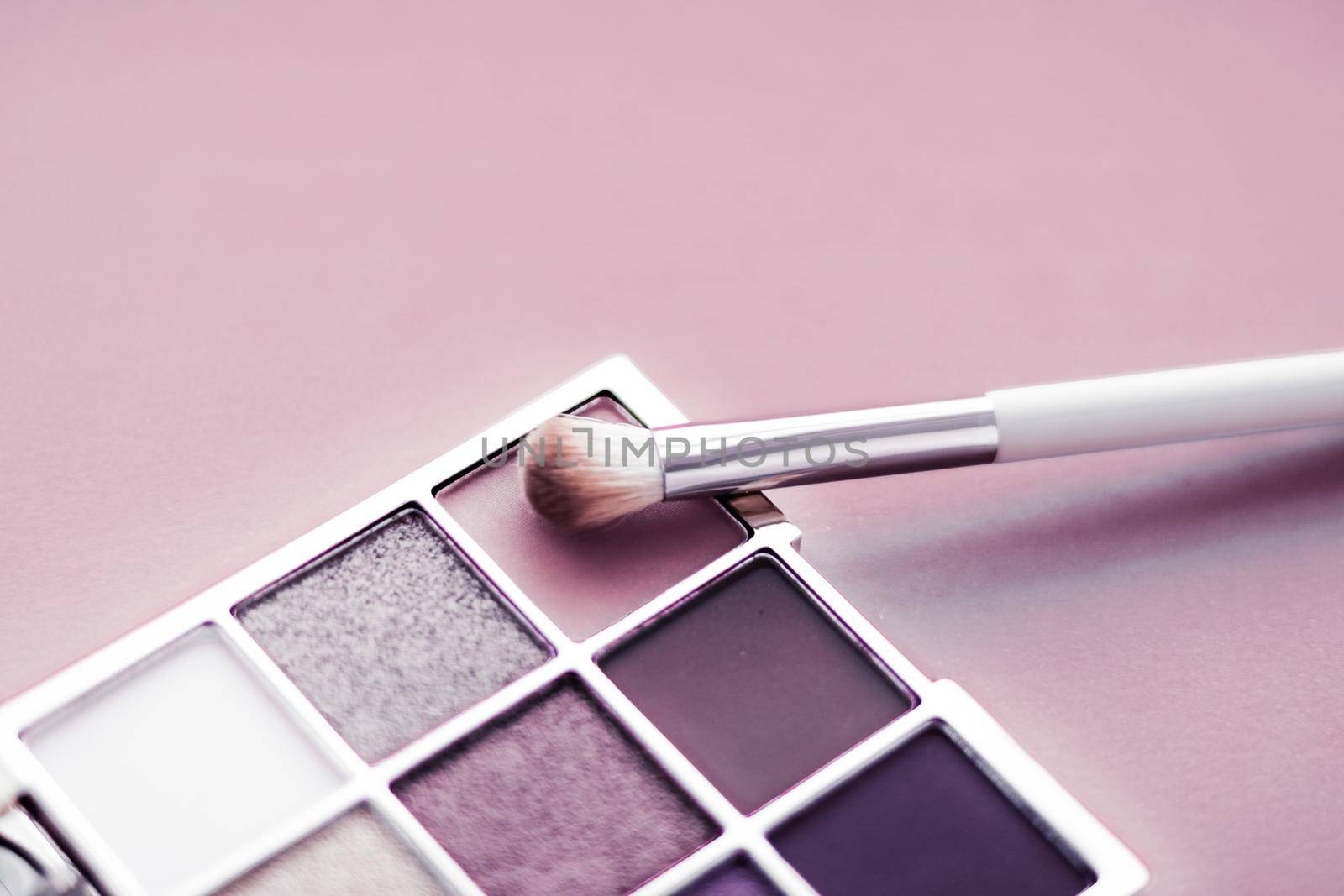 Cosmetic branding, mua and girly concept - Eyeshadow palette and make-up brush on blush pink background, eye shadows cosmetics product as luxury beauty brand promotion and holiday fashion blog design