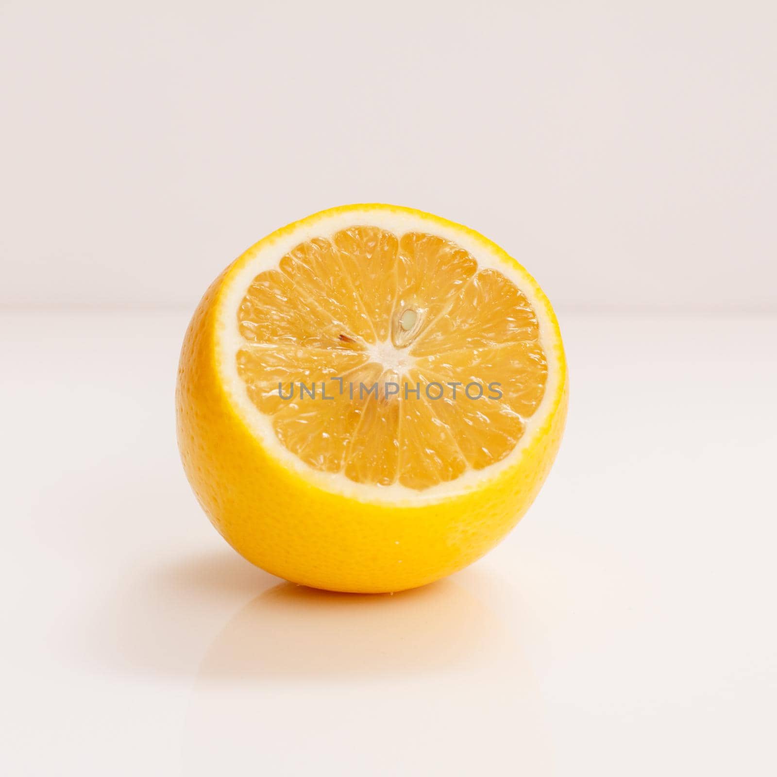 Juicy fresh cut lemon on the white background.