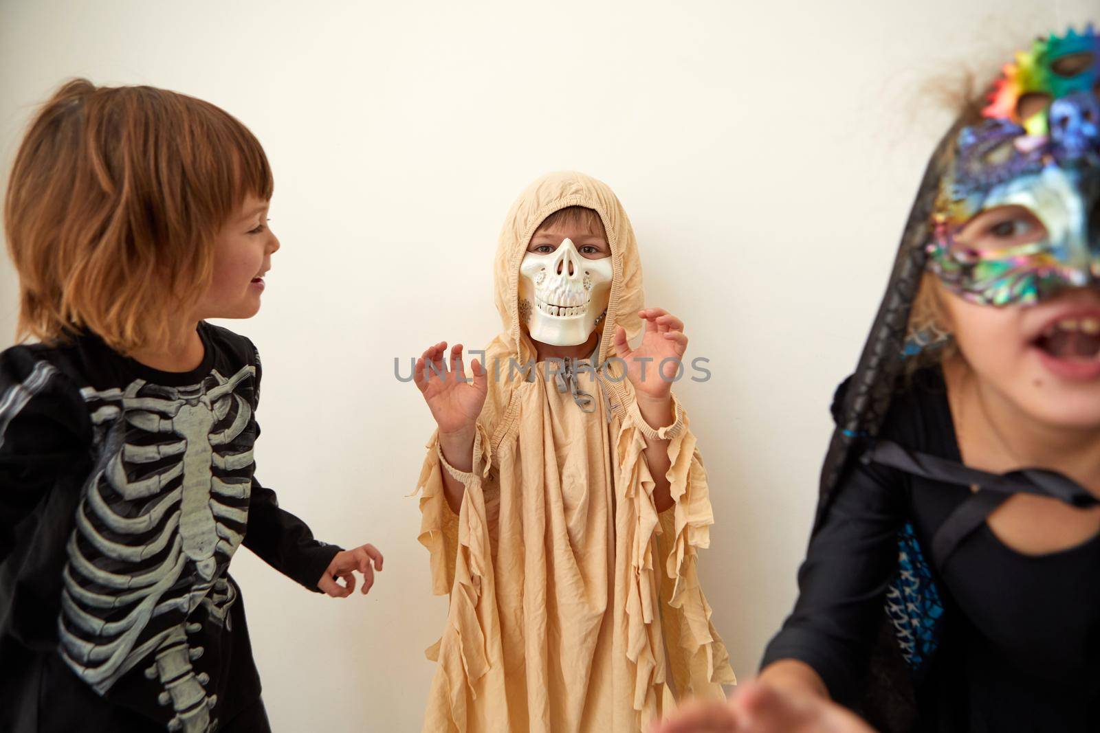 Children trick or treating on Halloween party, different costumes ghost, skeleton witch on white background