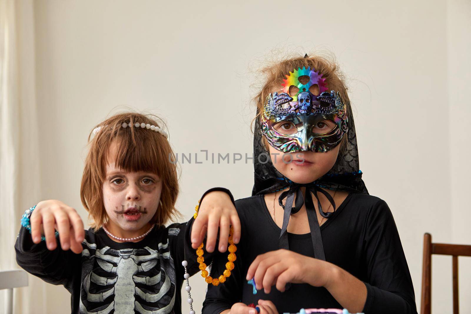 Children trick or treating on Halloween party different costumes decorated in jewelry skeleton and and cyberpunk mask witch white background