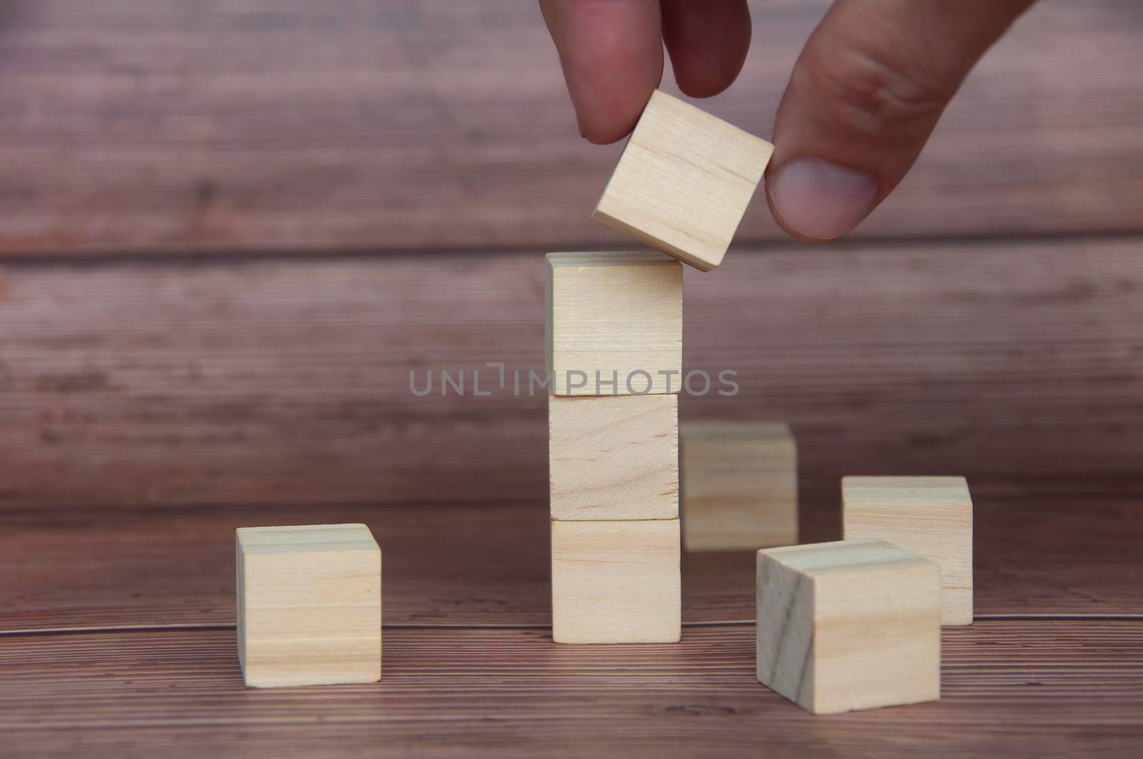 Hand holding wooden block with customizable space for text or ideas. Copy space.