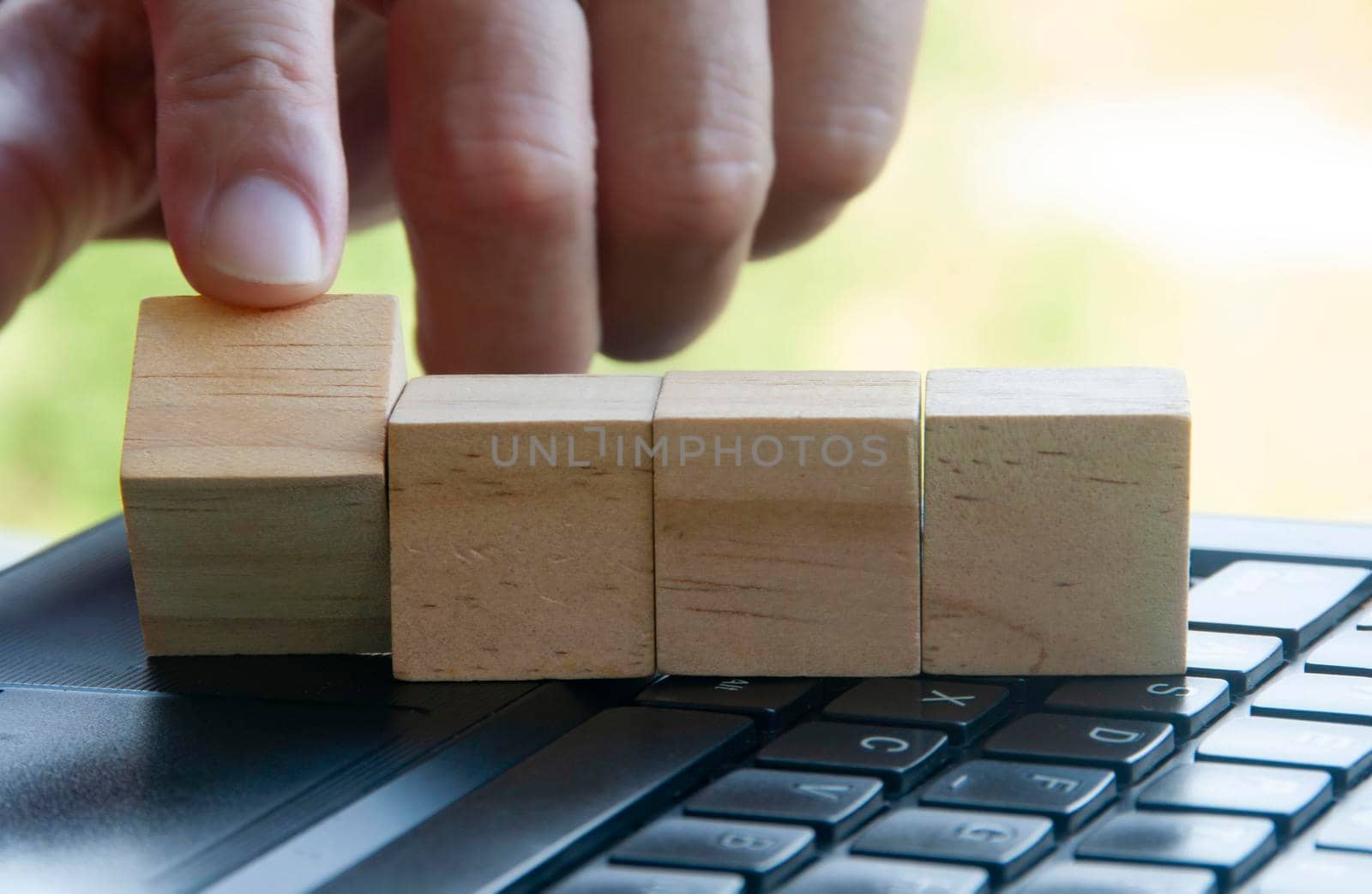 Finger flipping a wooden block with customizable space for text or ideas. Copy space.