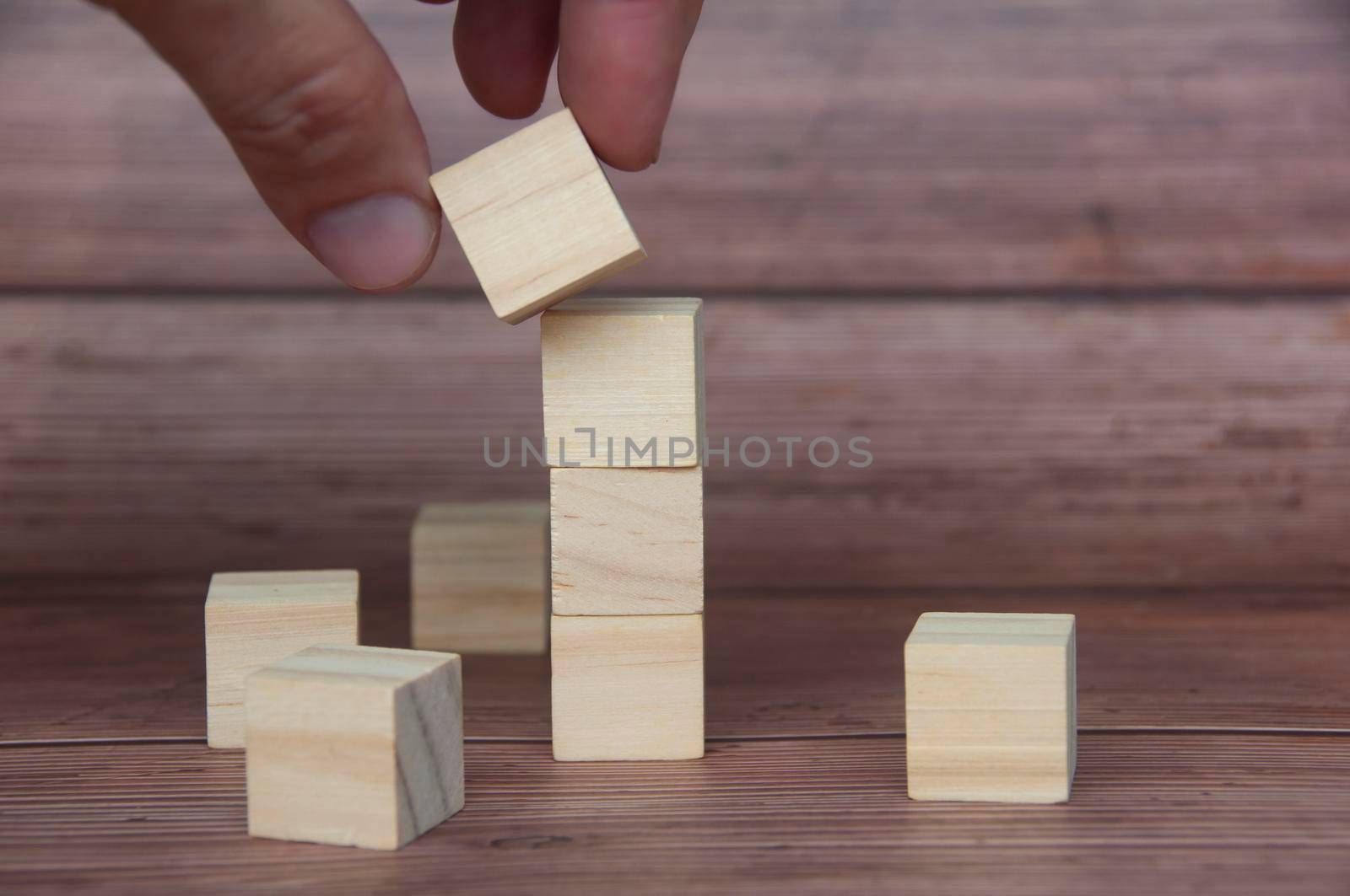 Hand holding wooden block with customizable space for text or ideas. Copy space