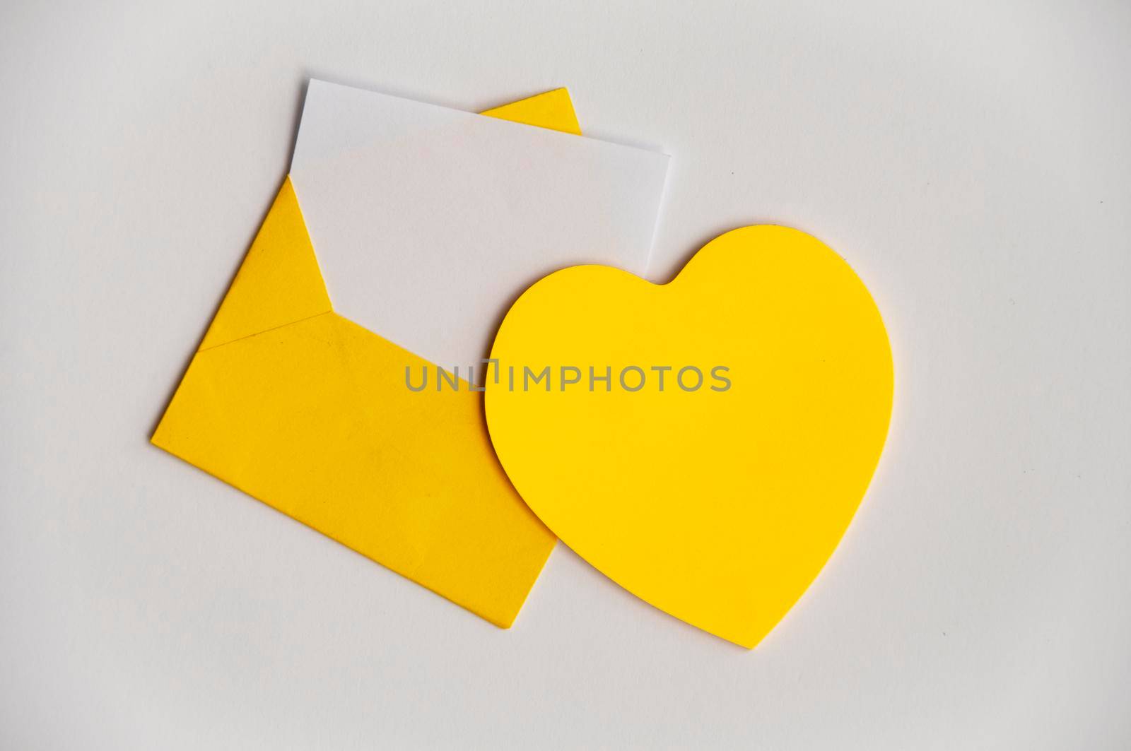 Blank heart shape notepad with envelope on white background with customizable space for text or ideas. Copy space and romance concept