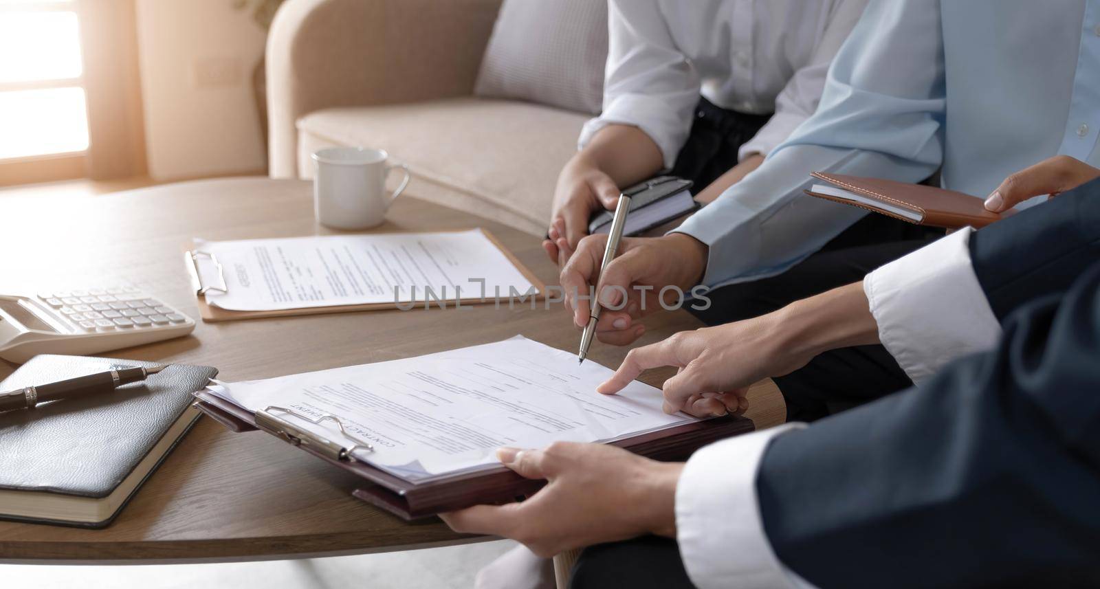 Real estate agent explaining and let customers sign a house purchase contract, discussing for contract to buy house, real estate concept and background. by wichayada