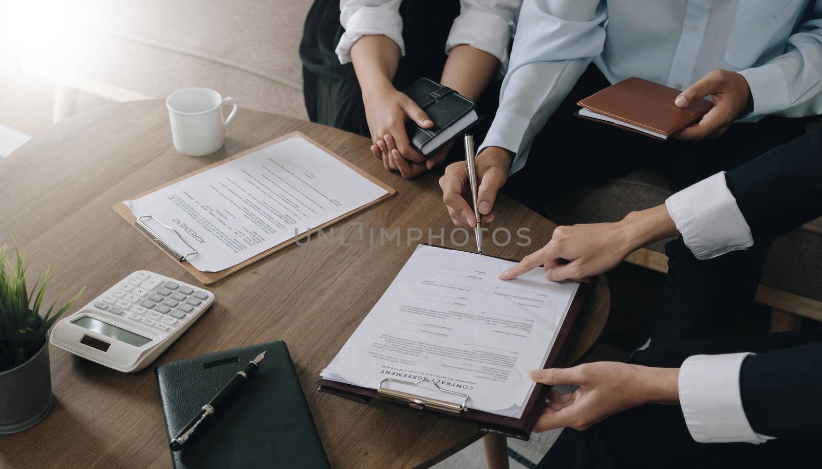 Real estate agent explaining and let customers sign a house purchase contract, discussing for contract to buy house, real estate concept and background..