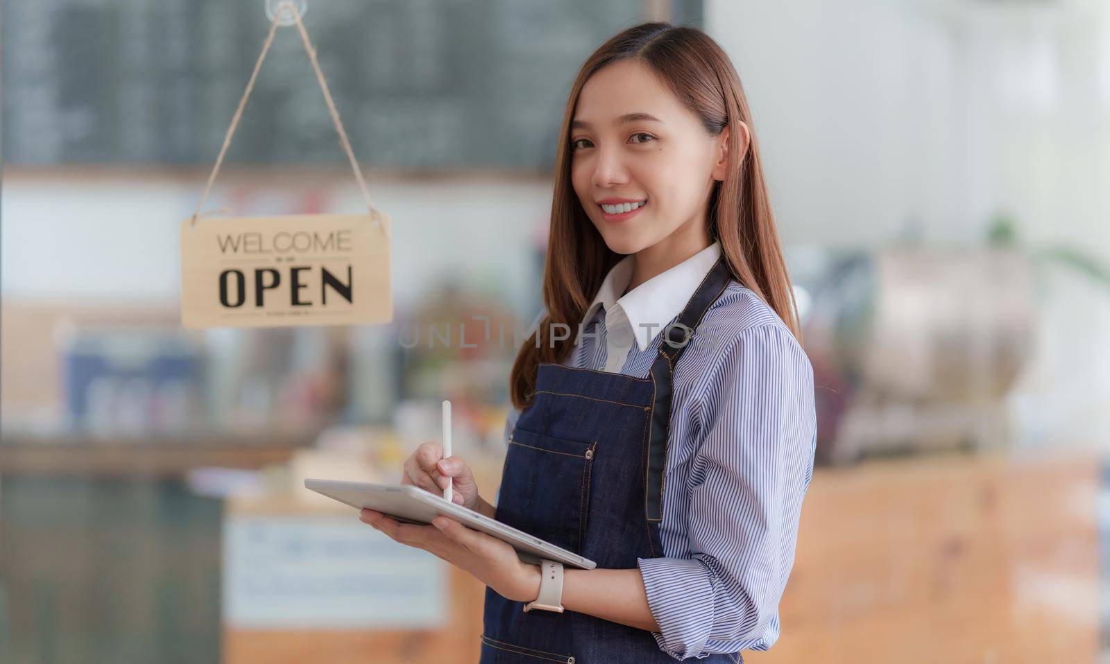 Asian Barista cafe owner smile while cafe open. SME entrepreneur seller business concept by itchaznong
