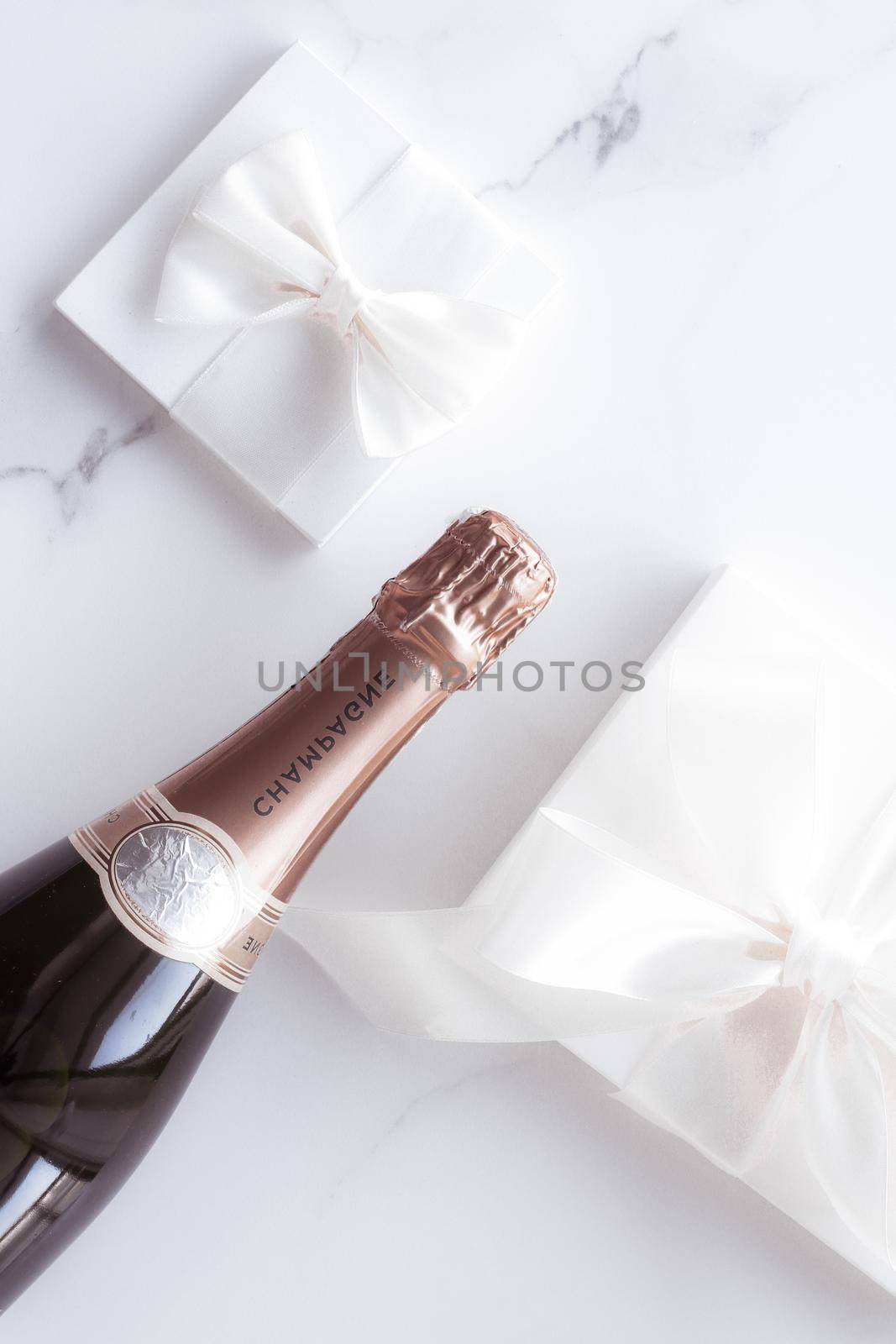 Champagne bottle and gift box on marble, New Years, Christmas, Valentines Day or wedding holiday present and luxury product packaging for beverage brand by Anneleven