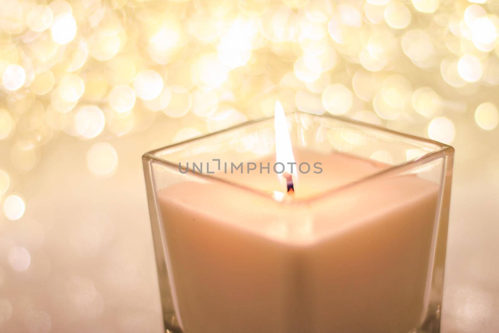 Festive decoration, branding and aromatherapy spa concept - Aromatic candle on golden Christmas and New Years glitter background, Valentines Day luxury home decor and holiday season brand design