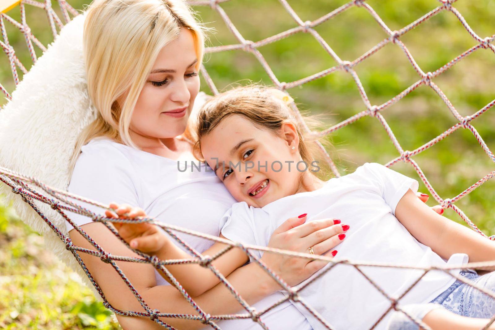Mother's day. Happy mother and daughter relaxing together in a hammock