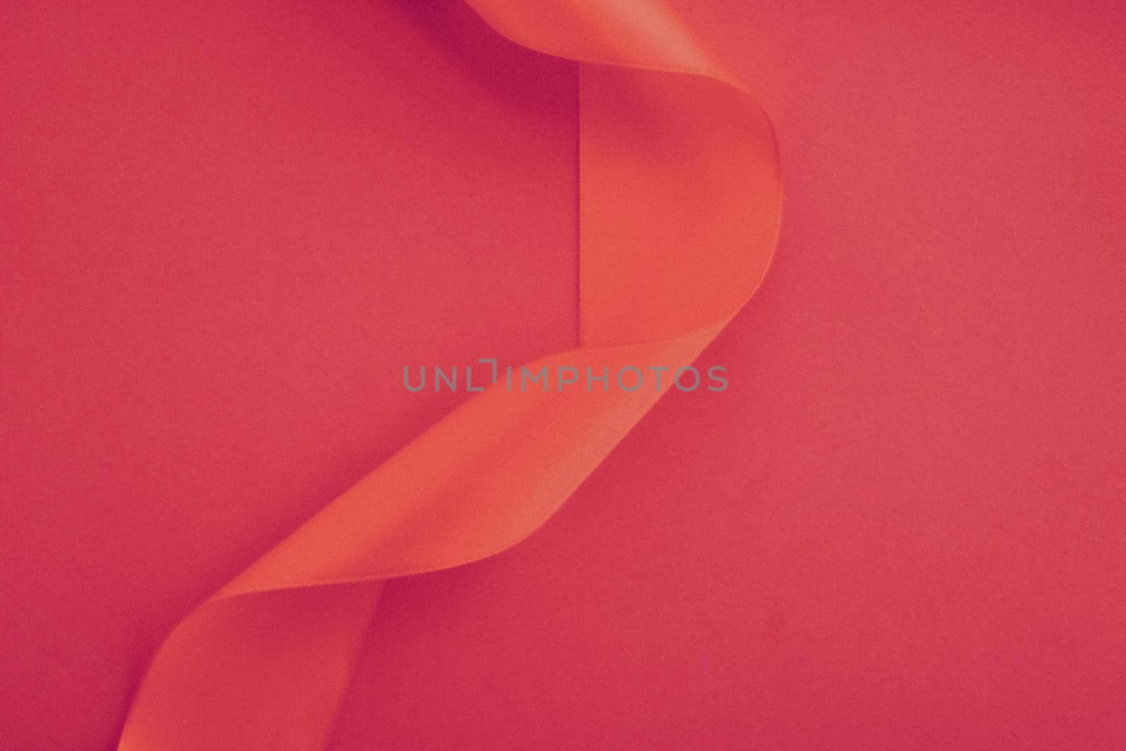 Branding, holidays and luxe brands concept - Abstract curly silk ribbon on rose background, exclusive luxury brand design for holiday sale product promotion and glamour art invitation card backdrop