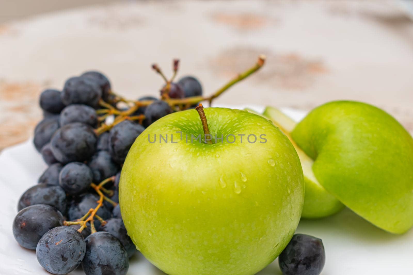 Delicious ripe and juicy green apples on the dining table