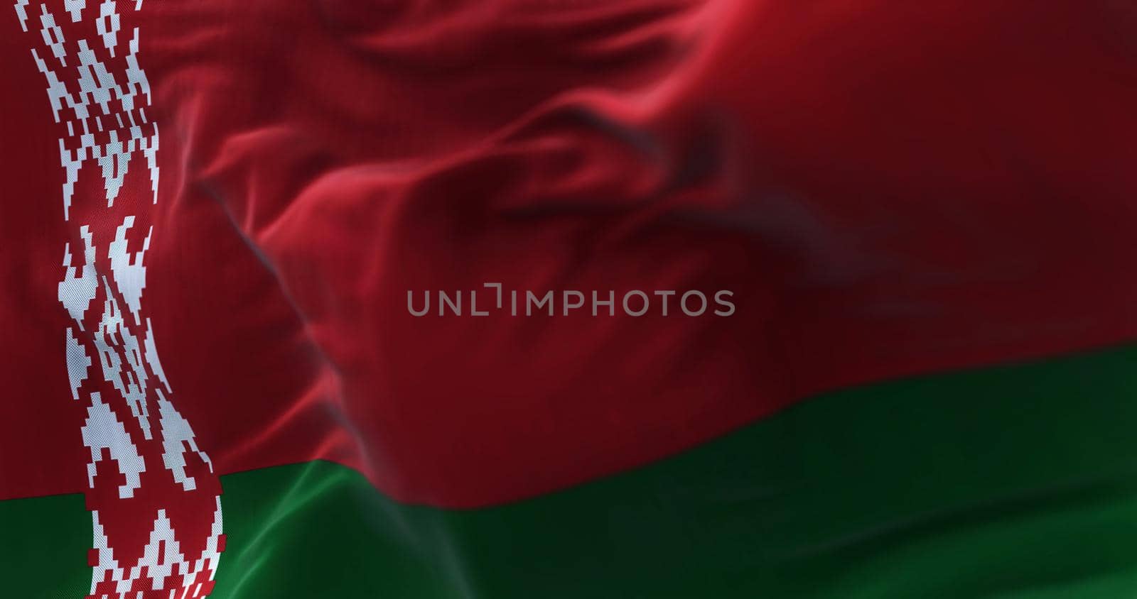 Close-up view of the belarusian national flag waving in the wind. The Republic of Belarus is a landlocked country in Eastern Europe. Fabric textured background. Selective focus