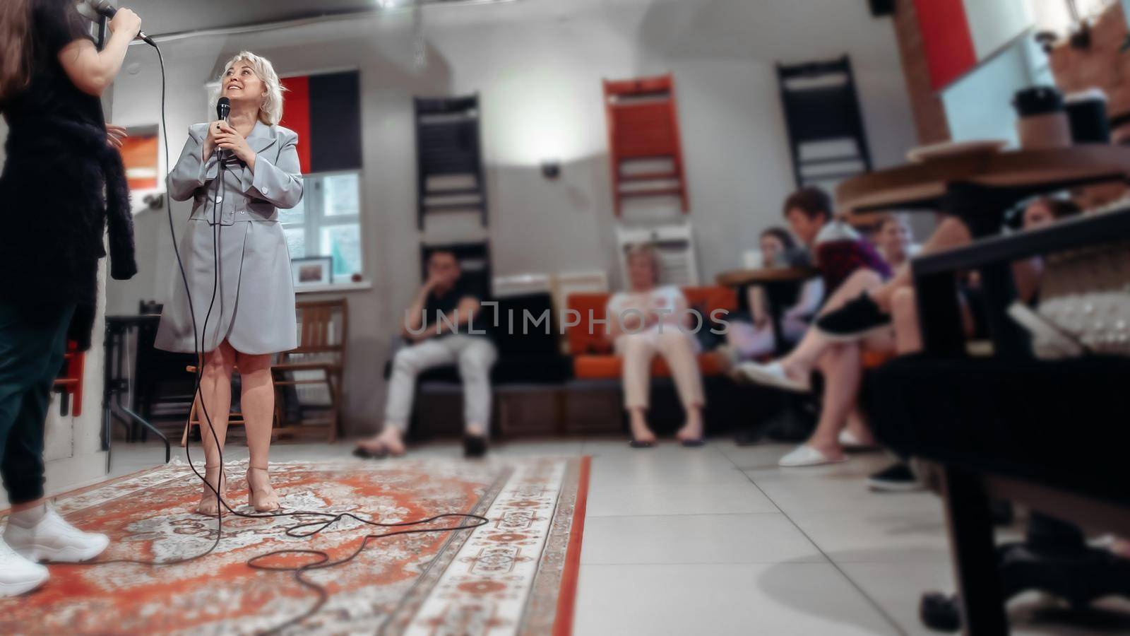 business woman and a team of image makers at a training on public speaking skills . by SmartPhotoLab