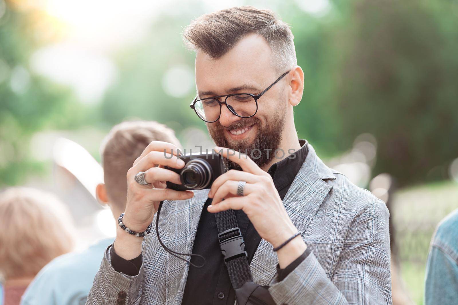 close-up. smiling male tourist looking at the screen of his camera.