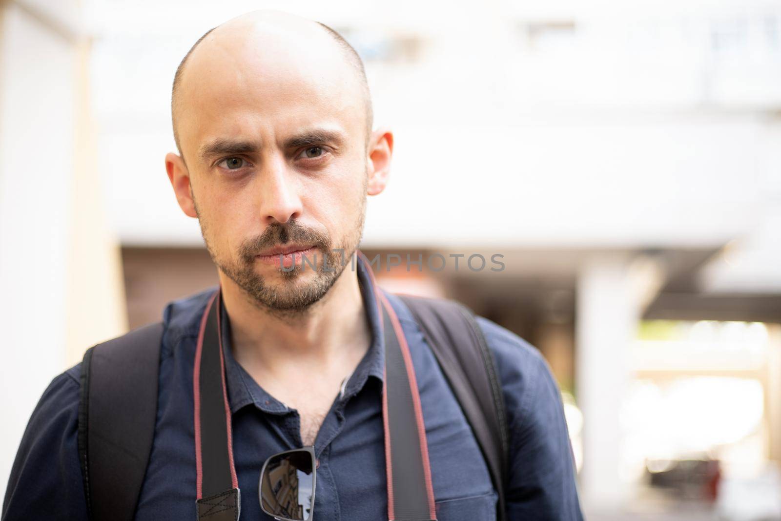 young man with a camera standing on a city street. photo with a copy space.