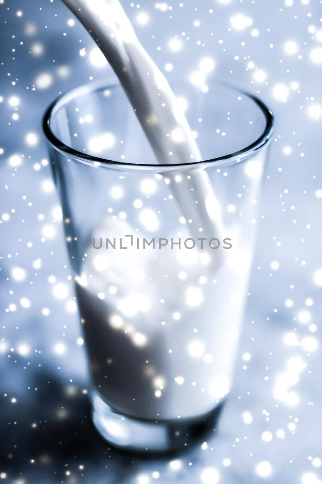 Magic holiday drink, pouring organic lactose free milk into glass on marble table by Anneleven