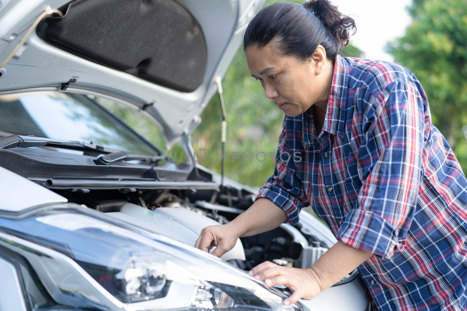 Open hood mechanic engine system to check and repair damage car crash.