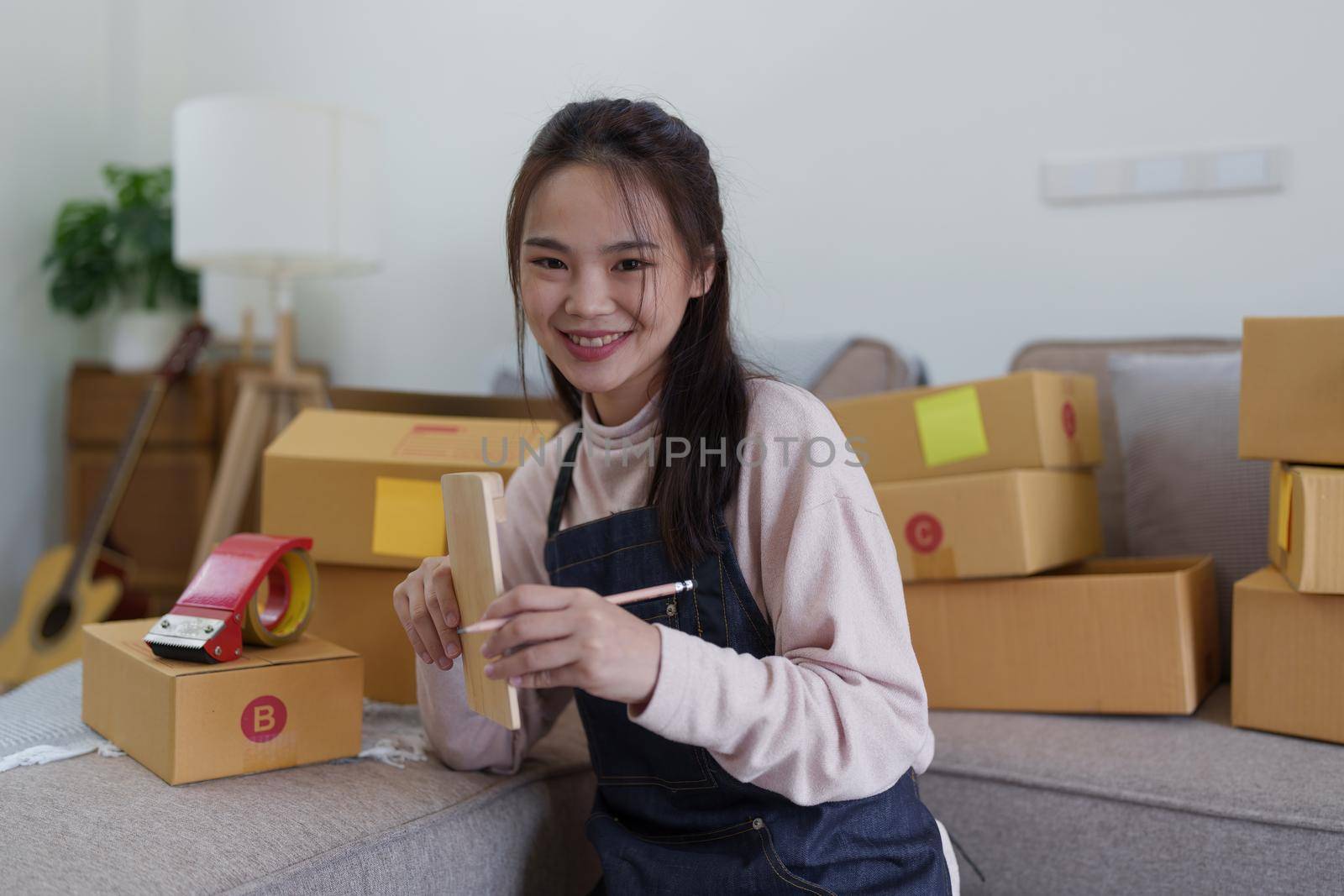 Asian SME business woman working at home office. online shopping concept by itchaznong