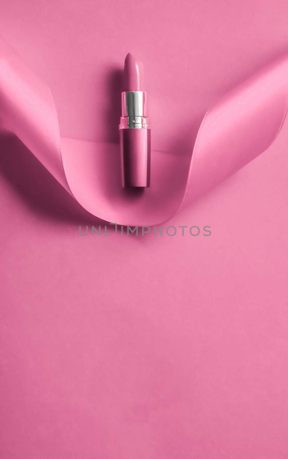 Cosmetic branding, glamour lip gloss and shopping sale concept - Luxury lipstick and silk ribbon on pink holiday background, make-up and cosmetics flatlay for beauty brand product design