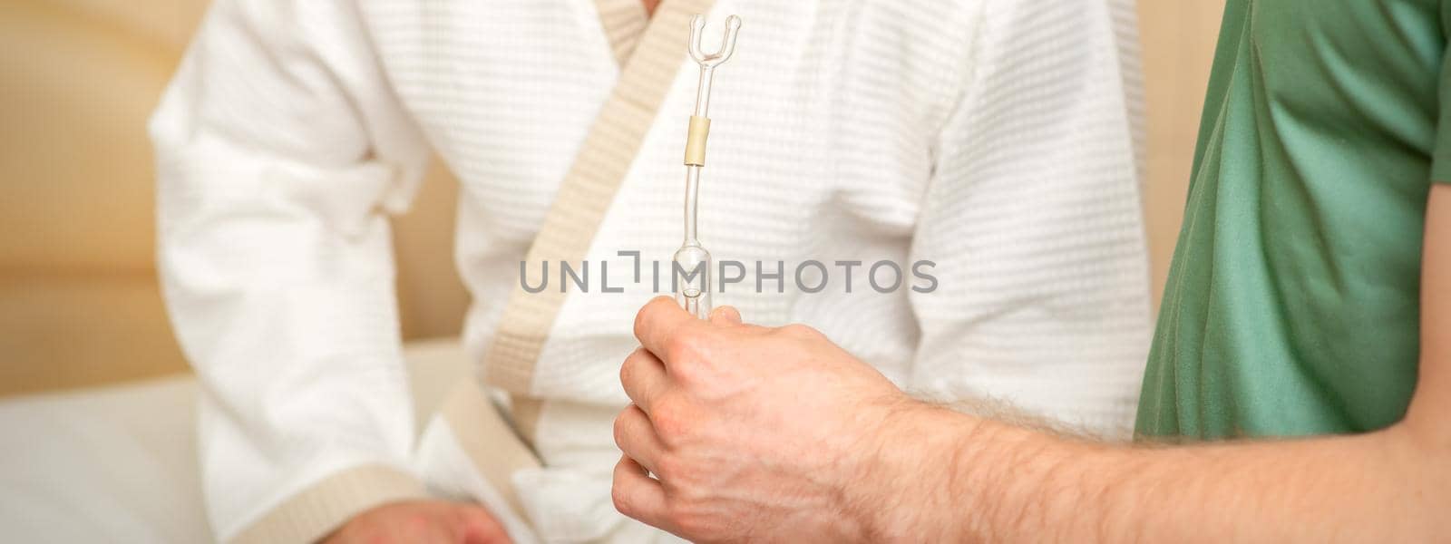 Doctor giving nasal inhalator with essential oil Maholda to a male patient in spa