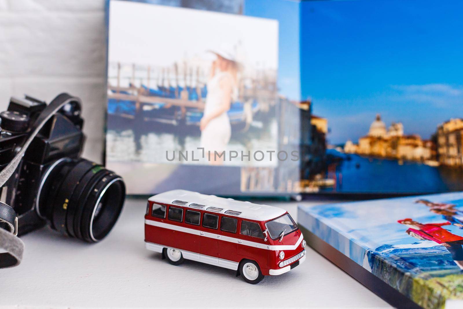 The concept of trip for a travel company. toy bus, plane and photo book, photo album by Andelov13