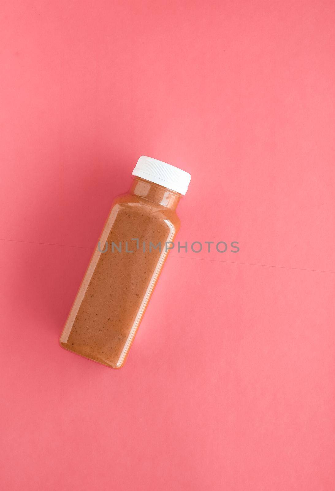 Detox superfood chocolate smoothie bottle for weight loss cleanse on.coral background, flatlay design for food and nutrition expert blog by Anneleven
