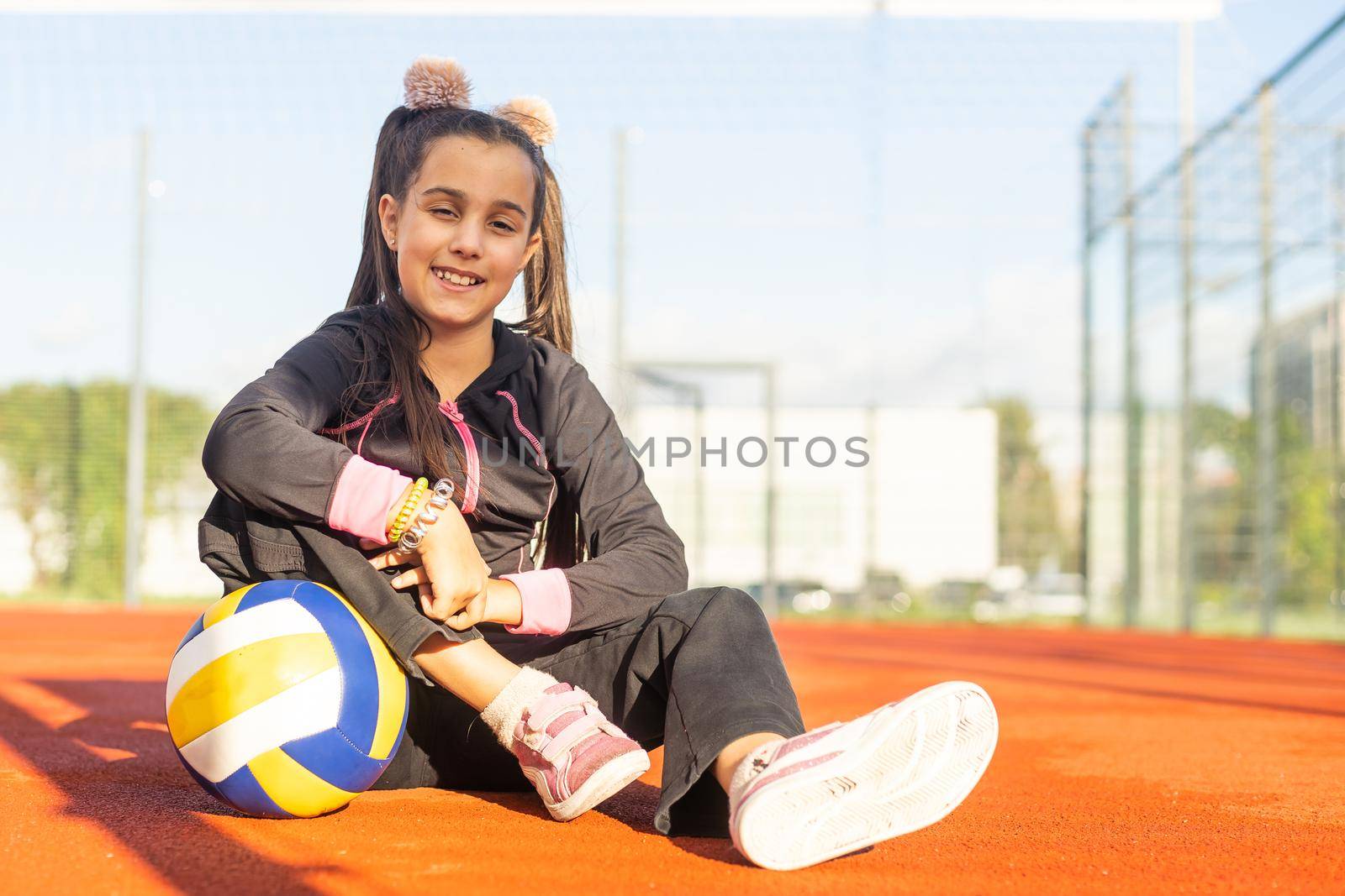 Cute girl playing ball. Girl with a blue-yellow volleyball by Andelov13