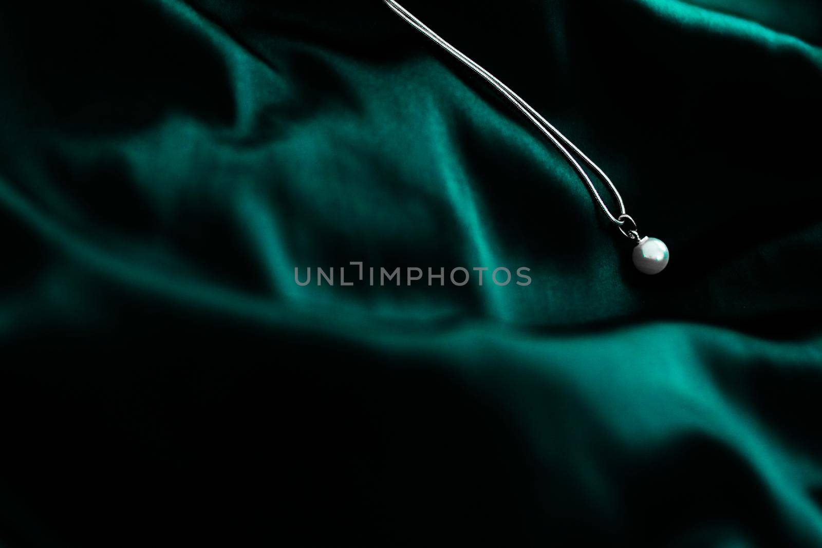 Jewellery brand, elegant fashion and bridal luxe gift concept - Luxury white gold pearl necklace on dark emerald green silk background, holiday glamour jewelery present