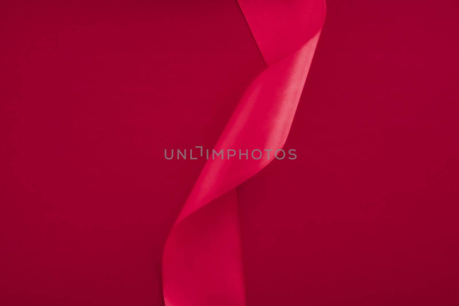 Branding, holidays and luxe brands concept - Abstract curly silk ribbon on pink background, exclusive luxury brand design for holiday sale product promotion and glamour art invitation card backdrop
