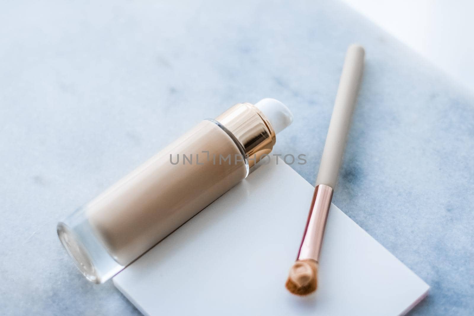 Makeup foundation bottle and contouring brush on marble, make-up concealer bb cream as cosmetics product for luxury beauty brand holiday design by Anneleven