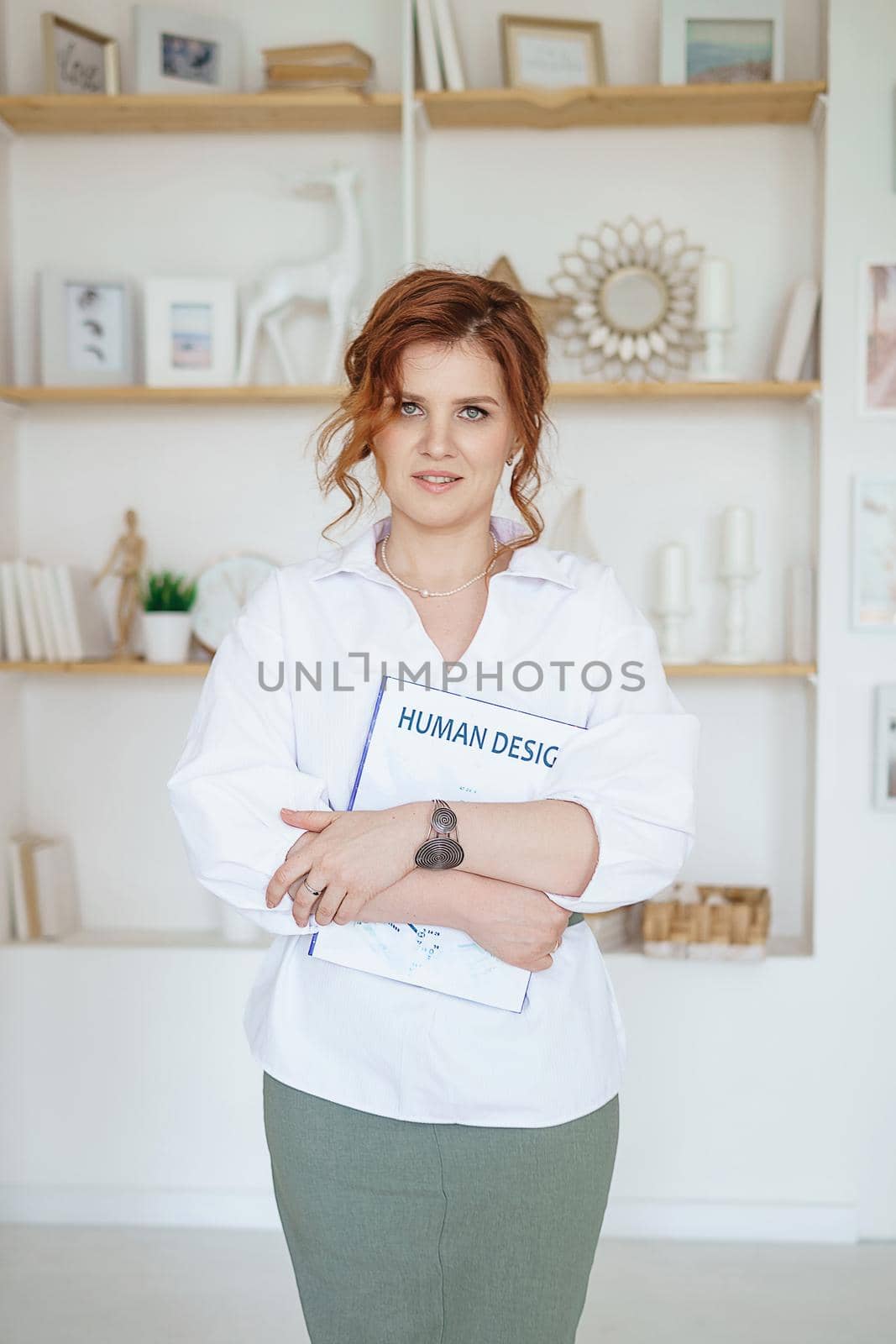 Tver, Russia-July 31, 2022 A business woman with a book on Human Design in her hands. A human design specialist works at home. Working at home during the epidemic