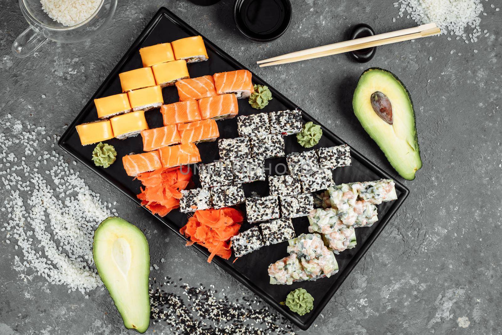 Sushi set with fresh ingredients on gray background. Sushi menu. Japanese food.