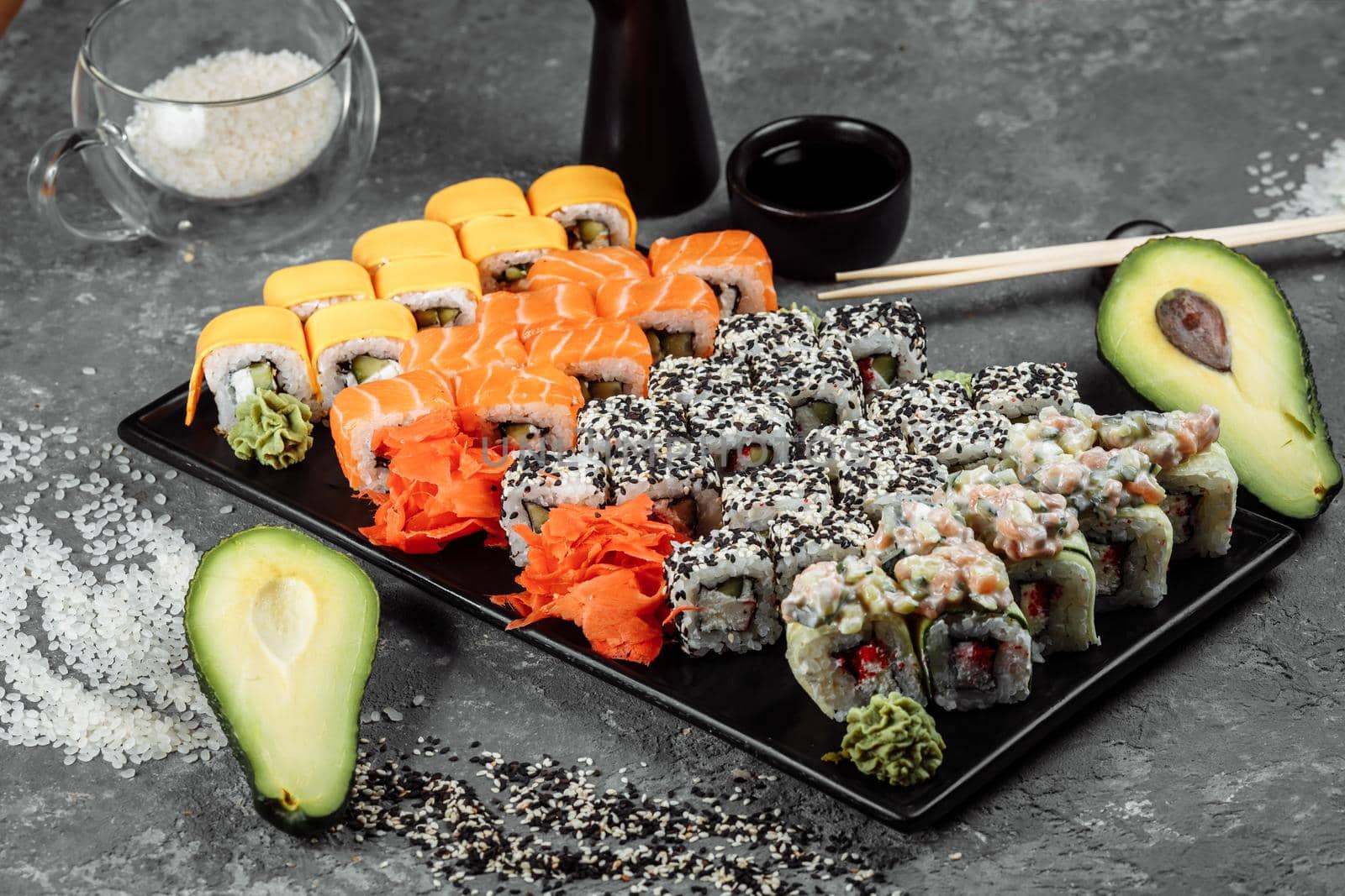 Sushi set with fresh ingredients on gray background. Sushi menu. Japanese food.