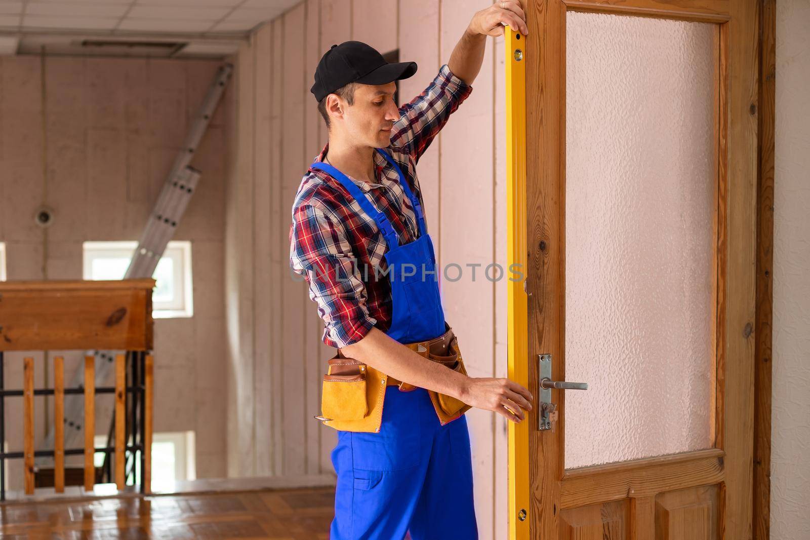 handyman repair the door lock in the room.