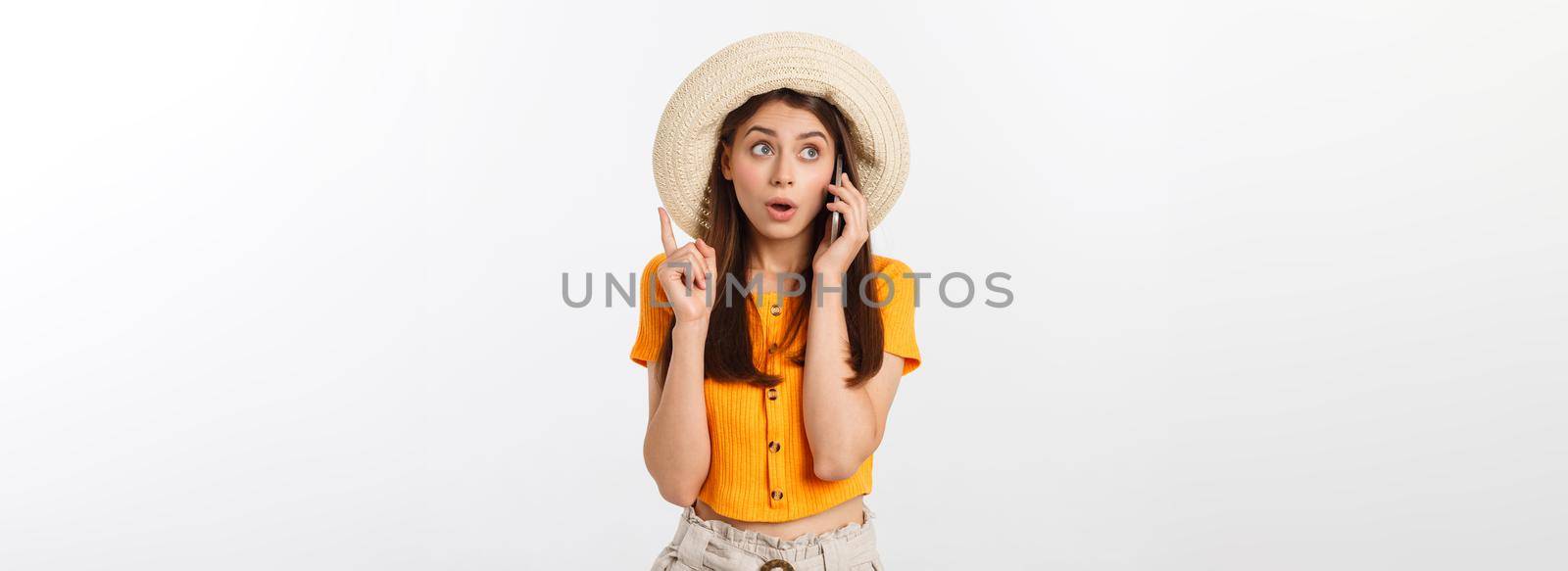 Picture of surprised voyage girl looking shock while holding phone in hands isolated over grey background by Benzoix