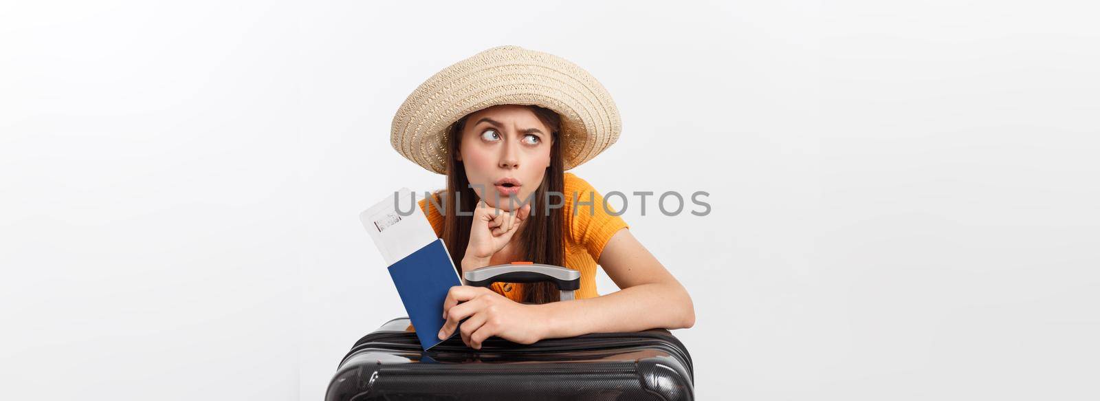 Lifestyle and travel Concept: Young beautiful caucasian woman is sitting on suitecase and waiting for her flight.Isolated over white background.