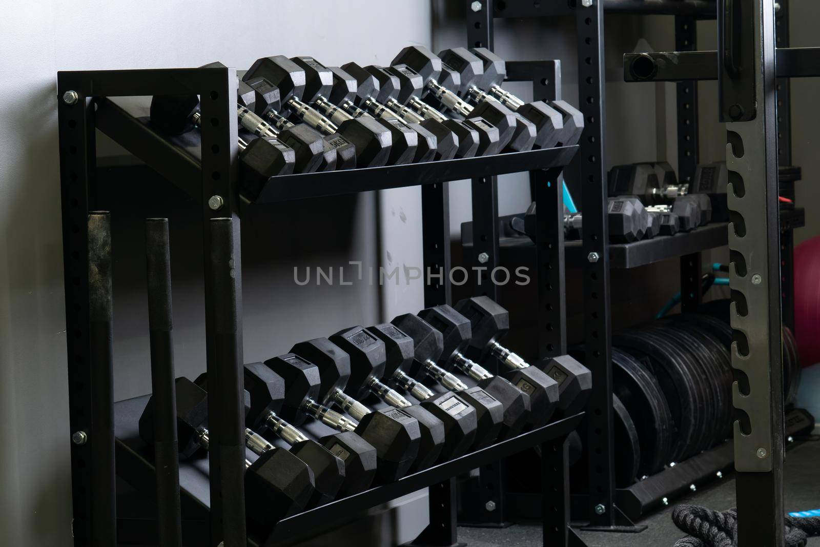 Dumbbell home gym blurry wall set storage rig equipment, concept studio taking in pick and exercise active, fit hard. Weightlifting ,