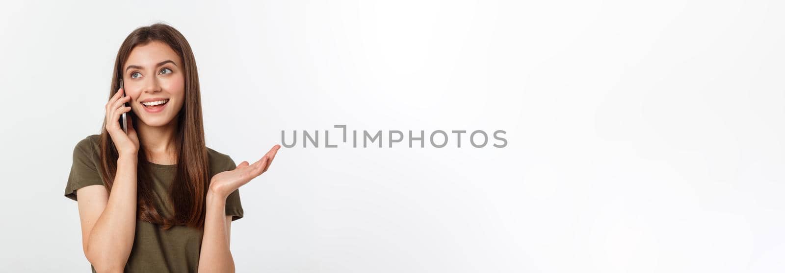 Laughing woman talking and texting on the phone isolated on a white background