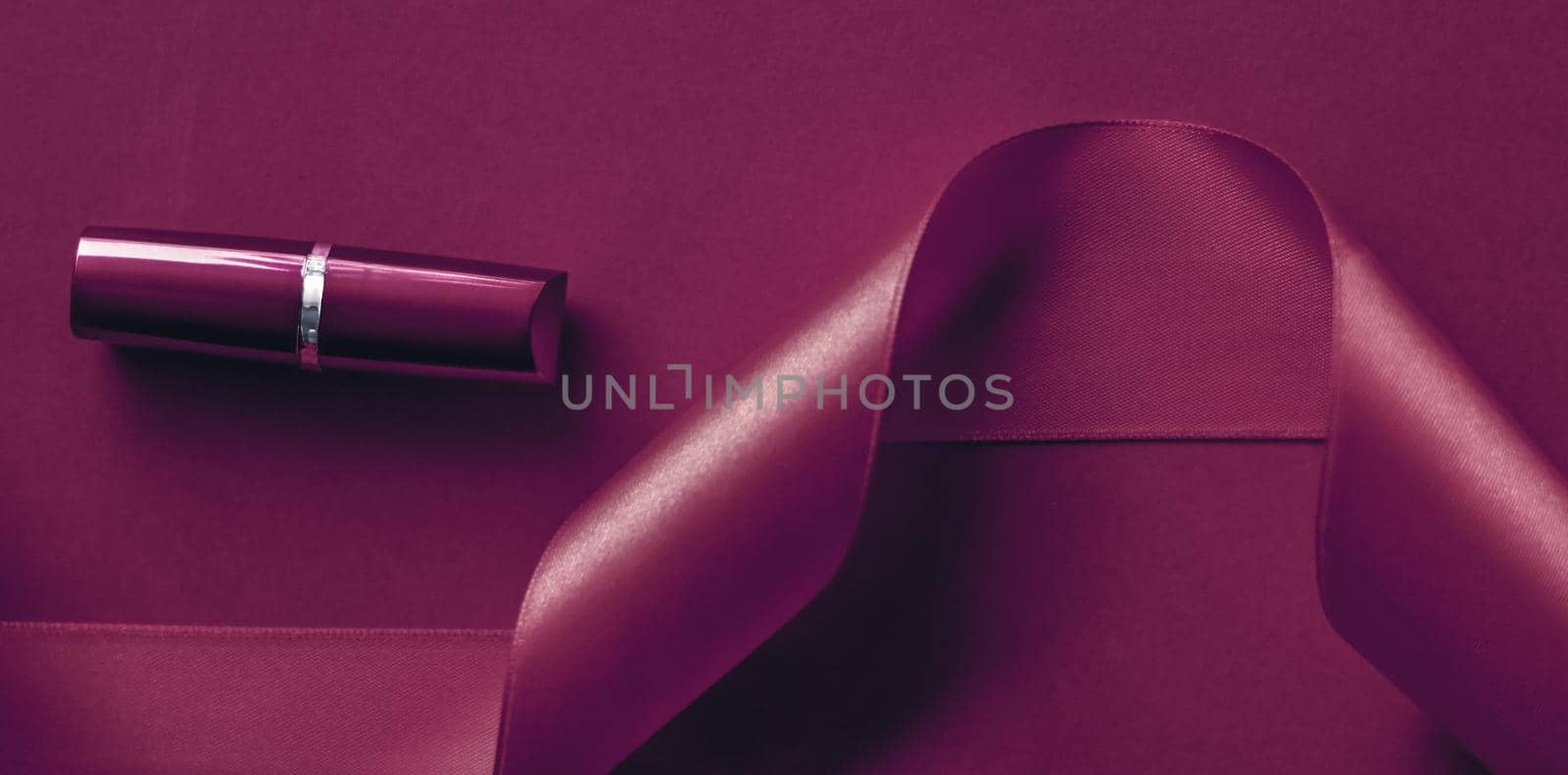 Cosmetic branding, glamour lip gloss and shopping sale concept - Luxury lipstick and silk ribbon on plum holiday background, make-up and cosmetics flatlay for beauty brand product design