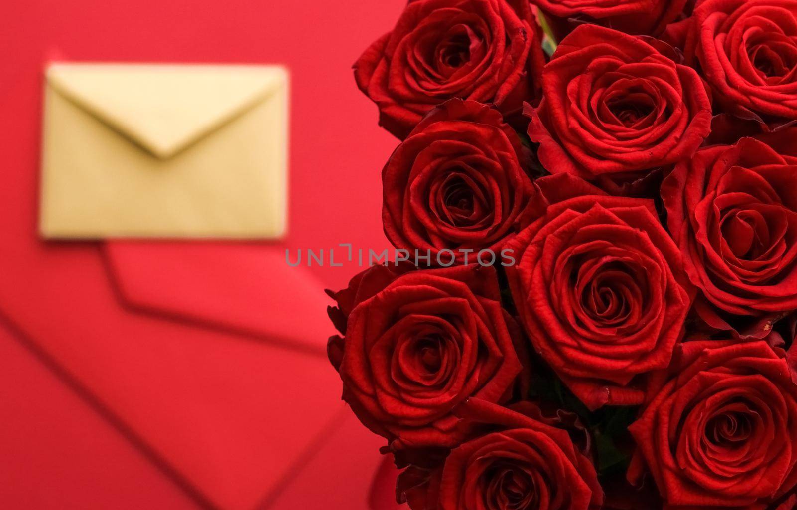 Holiday gift, flowers flatlay and happy relationship concept - Love letter and flower delivery service on Valentines Day, luxury bouquet of red roses and card envelopes on red background