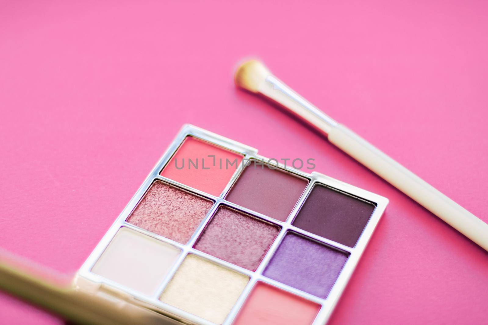 Cosmetic branding, mua and girly concept - Eyeshadow palette and make-up brush on rose background, eye shadows cosmetics product for luxury beauty brand promotion and holiday fashion blog design