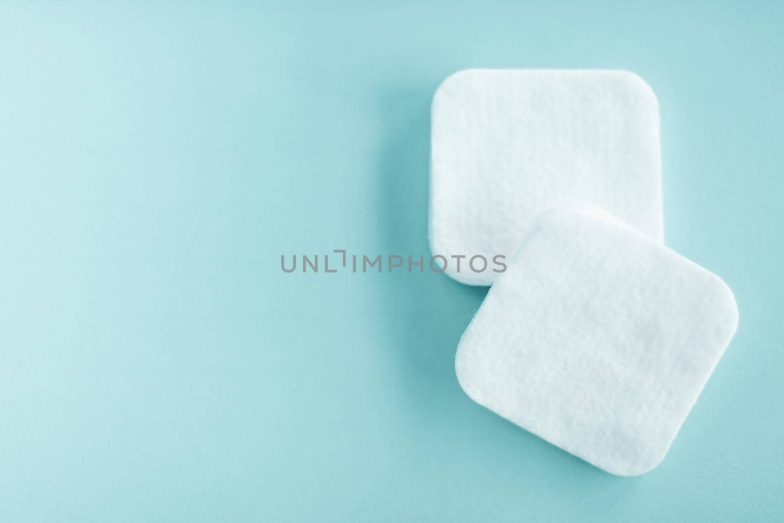 Cosmetology, cleanliness and branding concept - Organic cotton pads on mint background, cosmetics and make-up remover, hygiene and skincare beauty brand product for healthcare and medical design