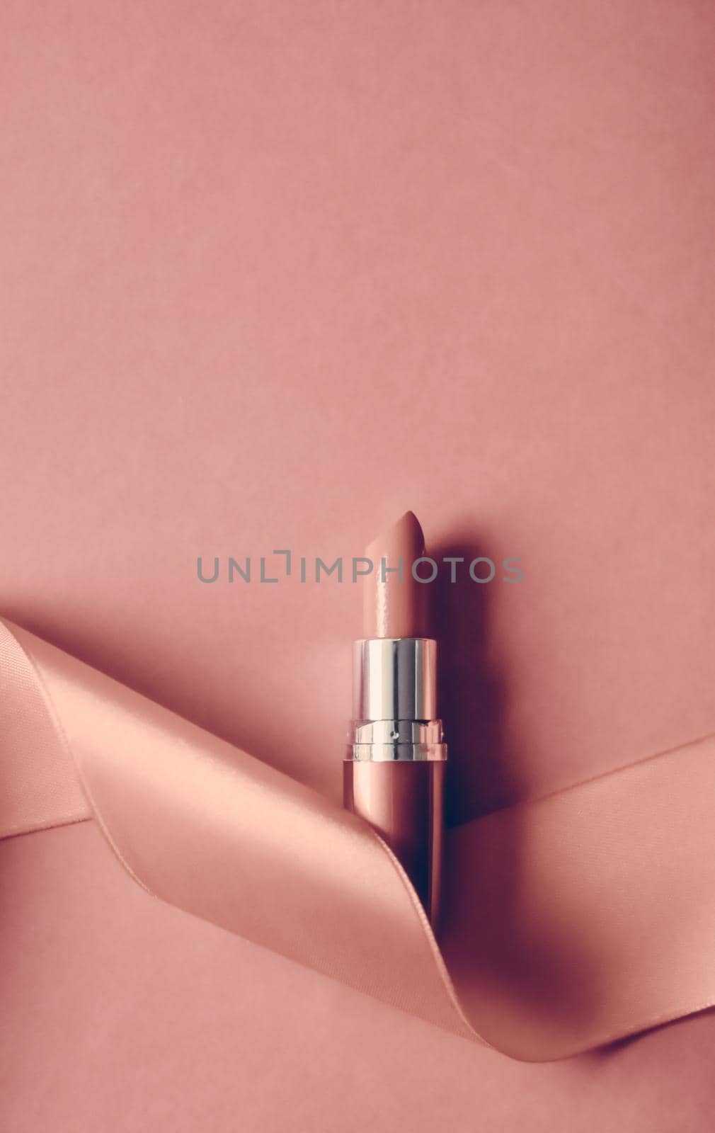 Cosmetic branding, glamour lip gloss and shopping sale concept - Luxury lipstick and silk ribbon on blush pink holiday background, make-up and cosmetics flatlay for beauty brand product design