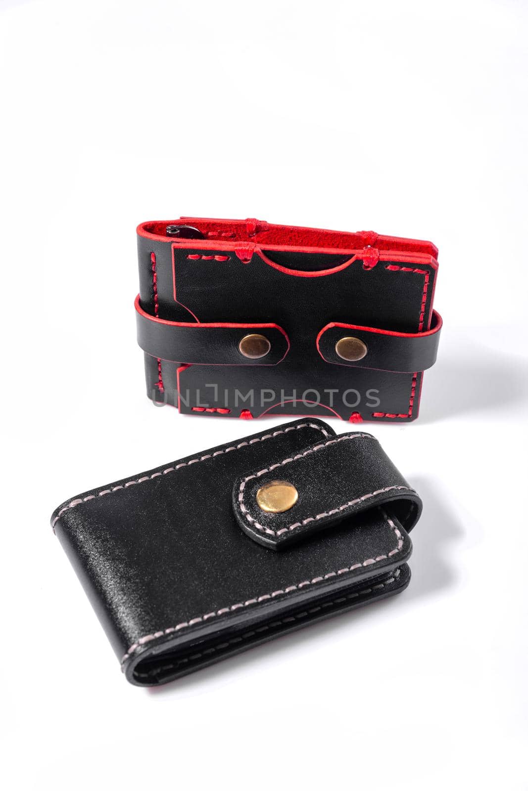 Luxury craft business card holder case and black mans wallet made of leather isolated on white background.
