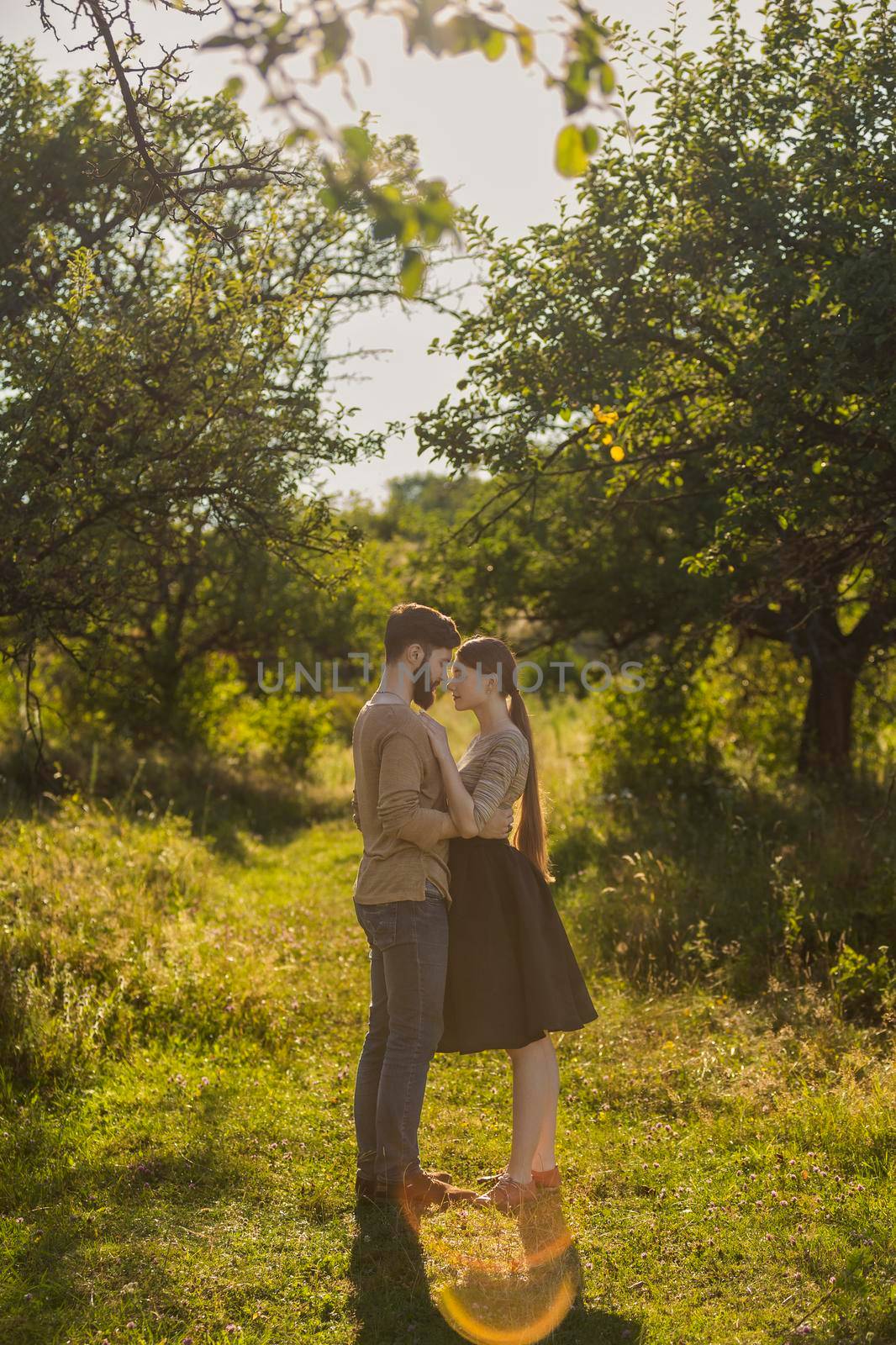 young couple hugging on nature background